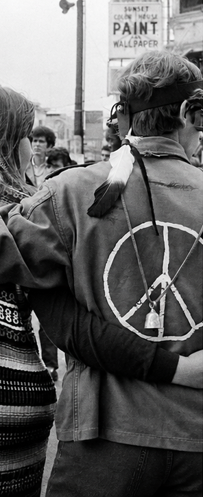 People in 1960s counterculture clothing.